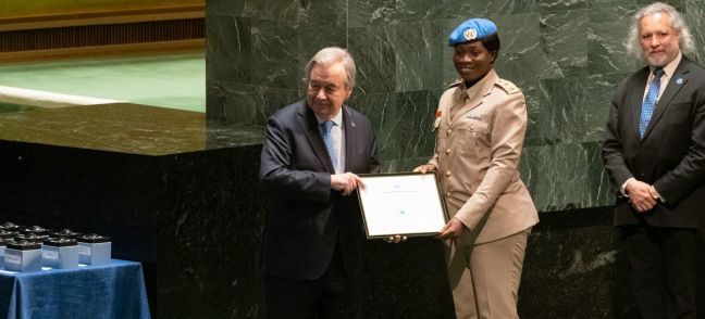 UN Photo/Evan Schneider The UN Secretary-General António Guterres (left) presents the 2022 Military Gender Advocate of the Year Award to Captain Cecilia Erzuah from Ghana who served with the UN Interim Security Force for Abyei (UNISFA).