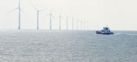 © Ruichen Hu A boat passes in front of an offshore wind power project close to Yancheng in eastern China.